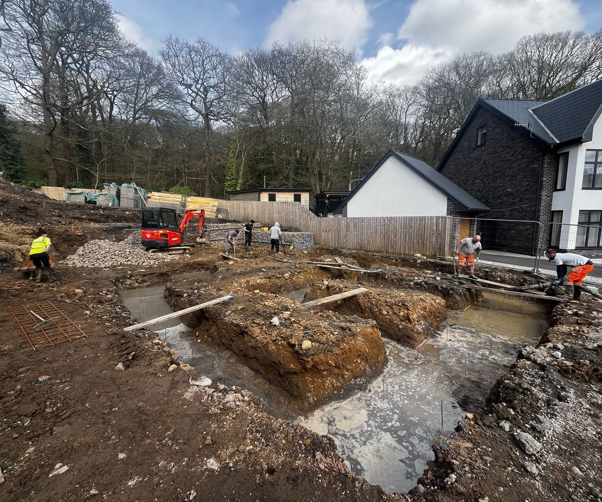 Excavation for foundations on a sloping site beside a new house