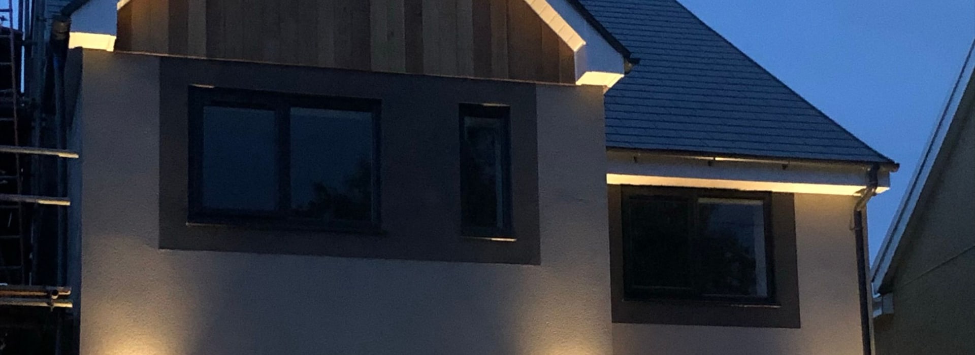 A finished detached new-build home at Heol Fawr, lit at dusk