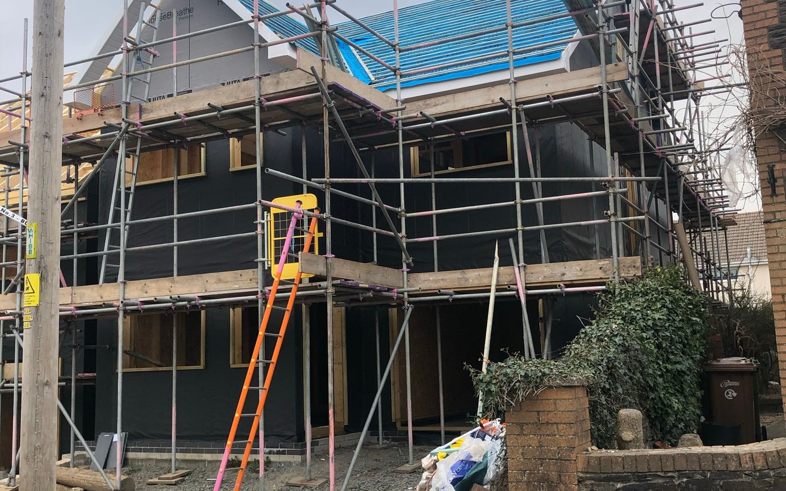 A timber-frame new-build home under scaffolding
